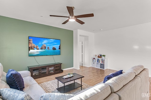 living room featuring ceiling fan and light hardwood / wood-style flooring