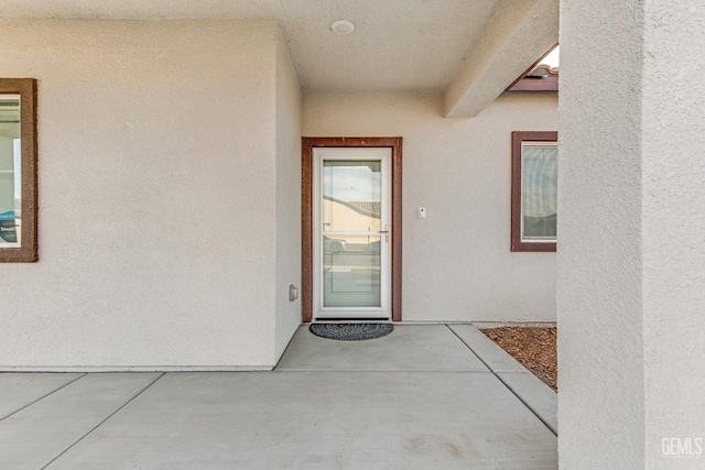 entrance to property featuring a patio