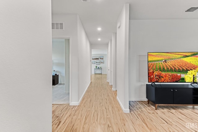 corridor with hardwood / wood-style flooring