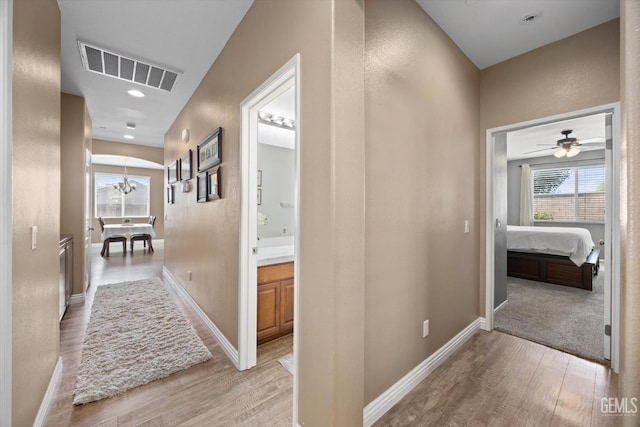 9318 Poseidon St, Bakersfield, CA 93306 - hallway with light wood finished floors, healthy amount of natural light, a chandelier, and recessed lighting
