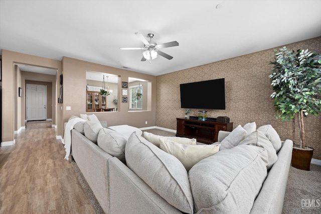 9318 Poseidon St, Bakersfield, CA 93306 - living room with wallpapered walls, ceiling fan, and light wood-style floors