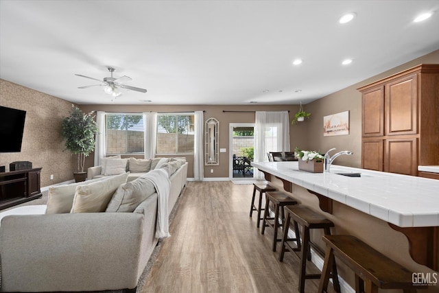 9318 Poseidon St, Bakersfield, CA 93306 - living room with light wood-style floors, recessed lighting, and ceiling fan