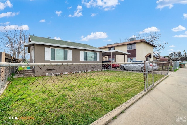 view of front of property with stucco siding, a fenced front yard, and a front yard