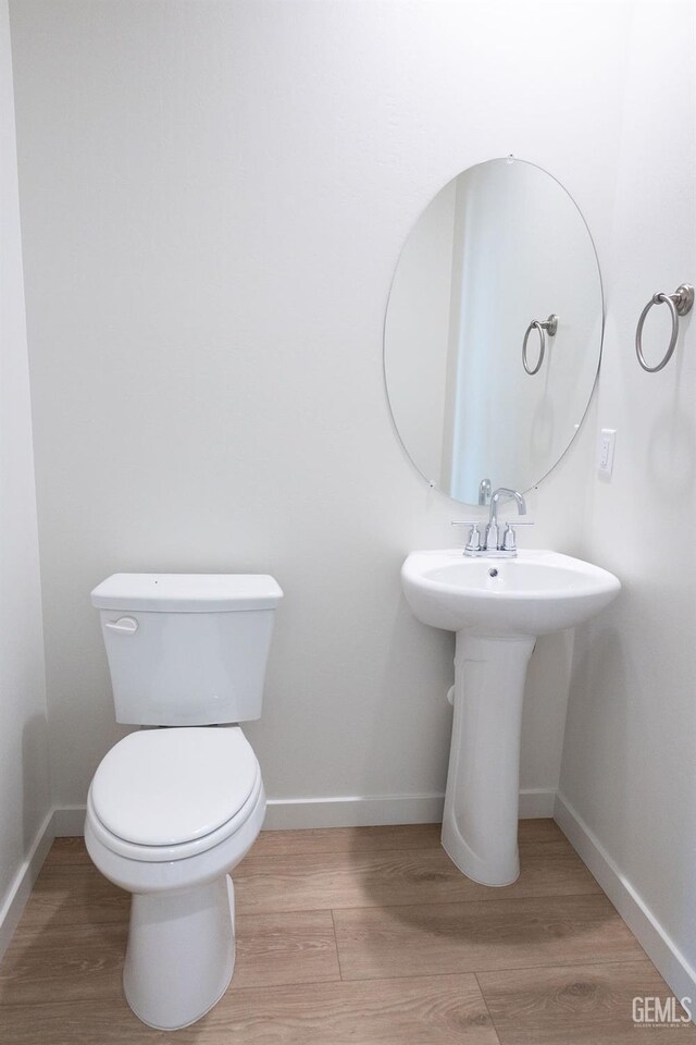 16615 Chloe Ct, Bakersfield, CA 93314 - bathroom with baseboards, toilet, and wood finished floors