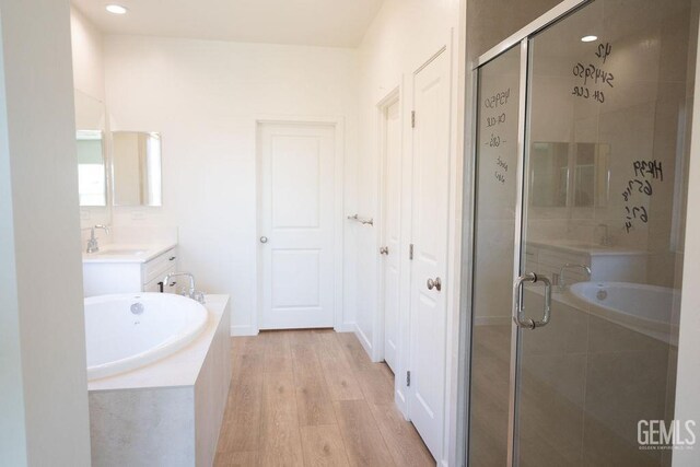 16615 Chloe Ct, Bakersfield, CA 93314 - full bathroom featuring a shower stall, wood finished floors, a bath, and vanity