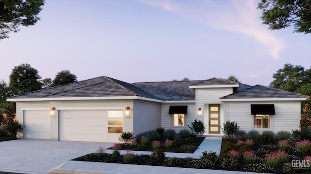 view of front of home with a garage and concrete driveway