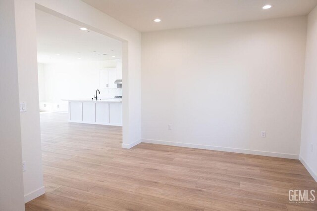 16615 Chloe Ct, Bakersfield, CA 93314 - unfurnished room featuring recessed lighting, baseboards, light wood-type flooring, and a sink