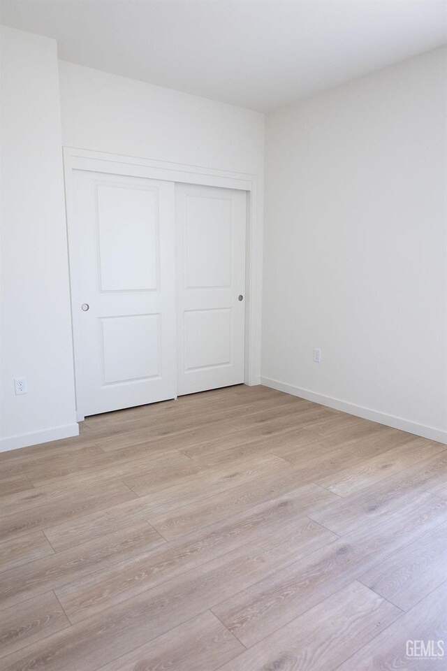 16615 Chloe Ct, Bakersfield, CA 93314 - unfurnished bedroom featuring a closet, light wood-style flooring, and baseboards