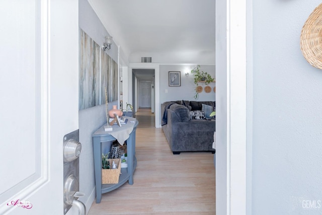 corridor with light wood-type flooring