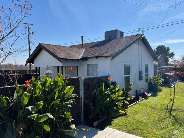 back of house with a lawn