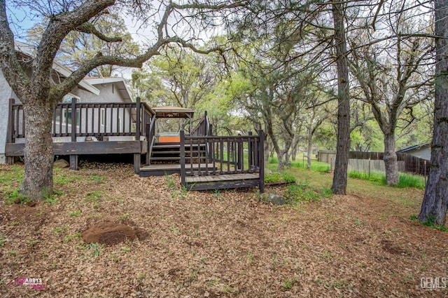 view of yard with fence and a deck