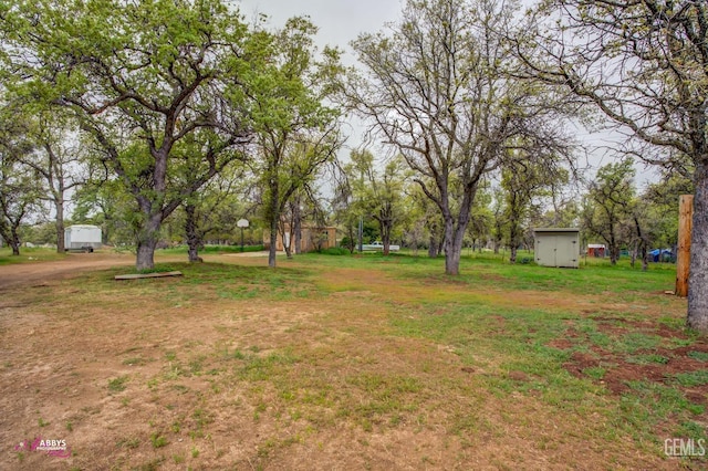 view of yard featuring an outbuilding and a storage shed