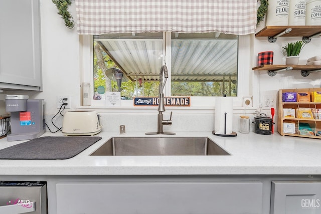kitchen featuring a sink and open shelves