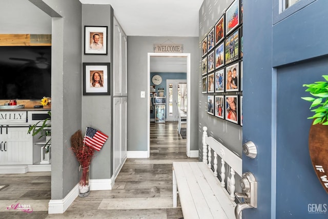hallway with baseboards and wood finished floors