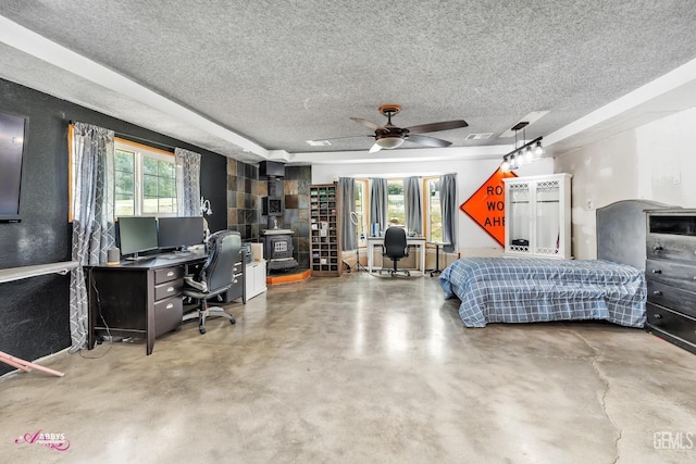 bedroom featuring a textured ceiling, multiple windows, and finished concrete flooring