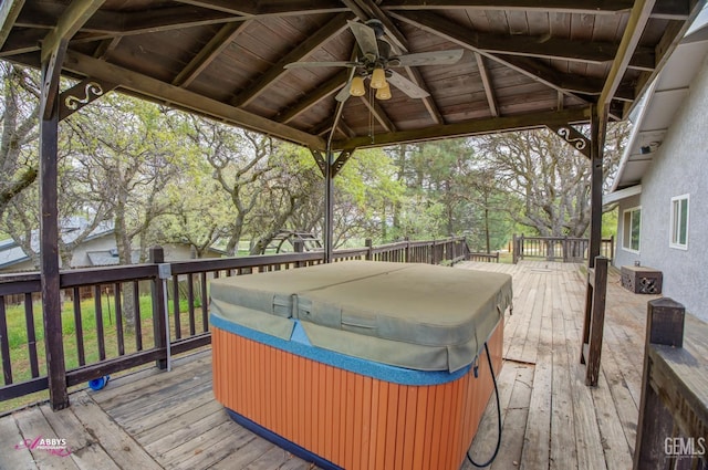 wooden deck with a gazebo, ceiling fan, and a hot tub