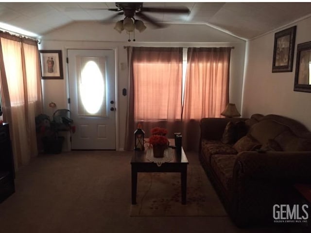 living room featuring vaulted ceiling, carpet floors, and ceiling fan