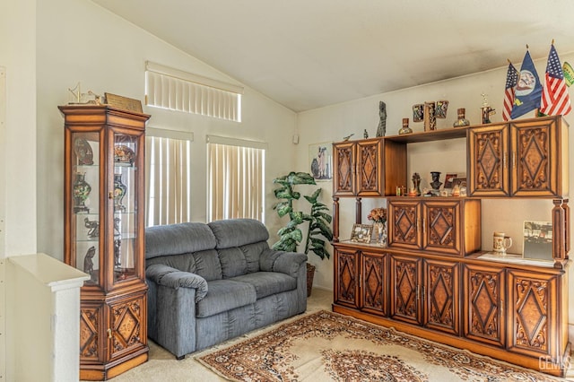 living area featuring carpet and vaulted ceiling