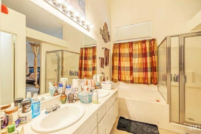 bathroom with a garden tub, double vanity, a stall shower, and a sink