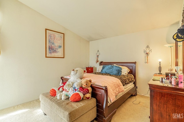 bedroom with lofted ceiling and carpet floors