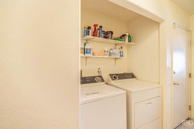 clothes washing area featuring laundry area and washing machine and clothes dryer