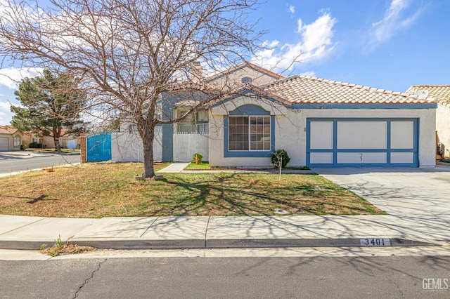 view of front of home with driveway, a tiled roof, an attached garage, a front lawn, and stucco siding