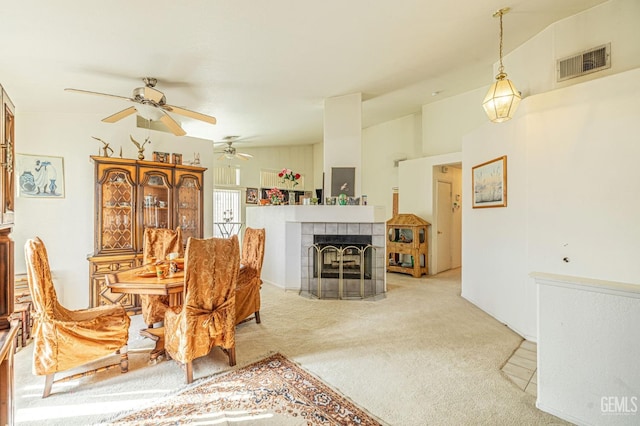 dining room with a fireplace, visible vents, carpet flooring, vaulted ceiling, and ceiling fan