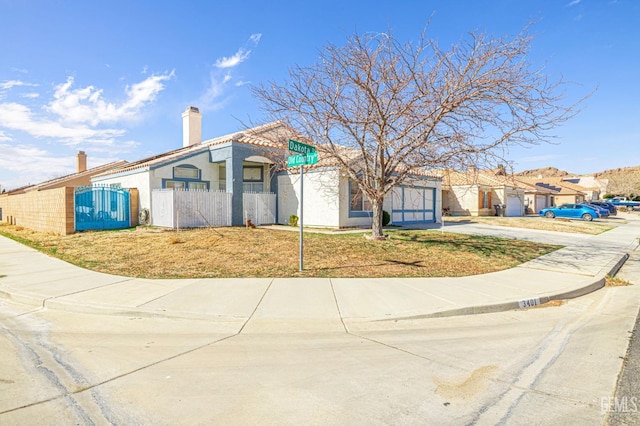 view of community featuring a fenced front yard and a gate