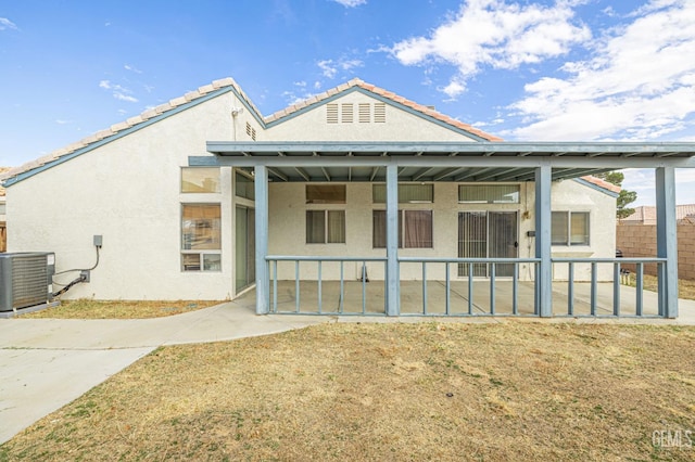 rear view of property with central air condition unit, fence, a patio, and stucco siding