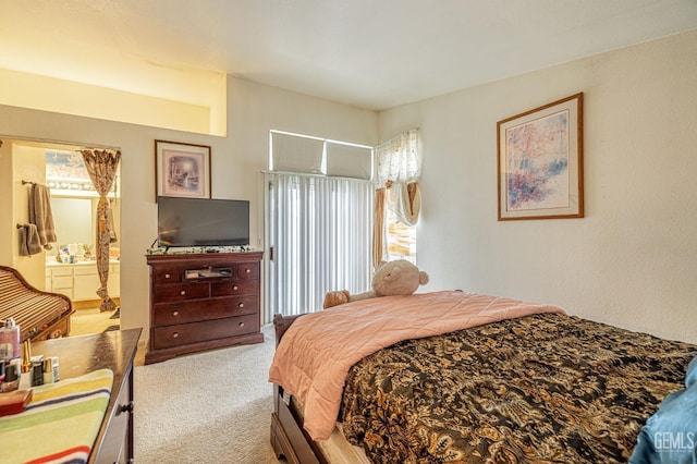 carpeted bedroom featuring ensuite bath