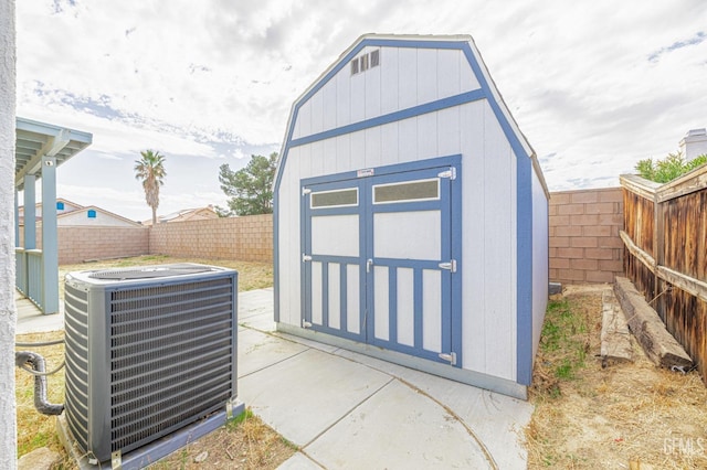 view of shed with central AC and a fenced backyard