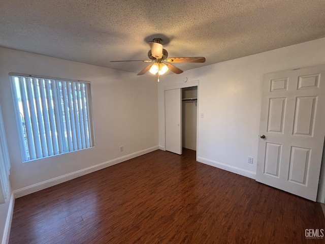 unfurnished bedroom with dark hardwood / wood-style flooring, ceiling fan, a closet, and a textured ceiling