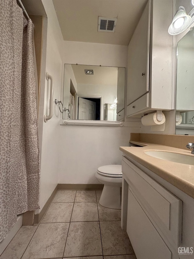 bathroom with vanity, tile patterned flooring, and toilet