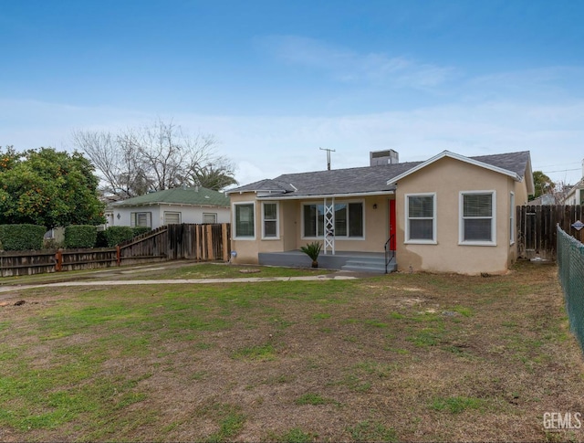 rear view of property featuring a yard