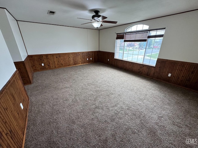 6100 Aruba Ct, Bakersfield, CA 93313 - carpeted empty room with wooden walls, wainscoting, and visible vents