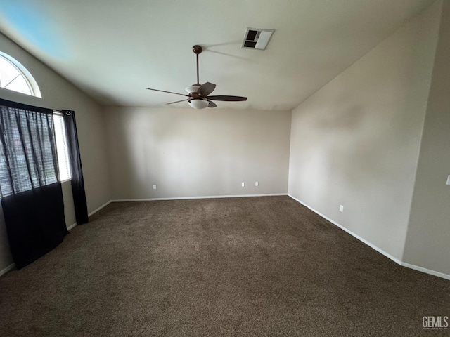 6100 Aruba Ct, Bakersfield, CA 93313 - empty room featuring visible vents, baseboards, dark carpet, lofted ceiling, and a ceiling fan