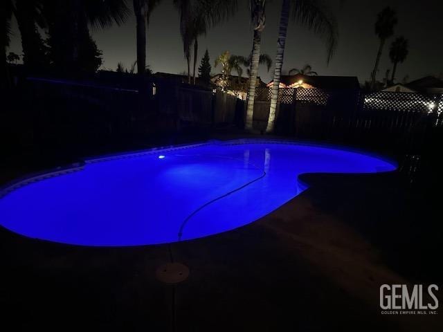 6100 Aruba Ct, Bakersfield, CA 93313 - pool at twilight with a fenced backyard and a fenced in pool