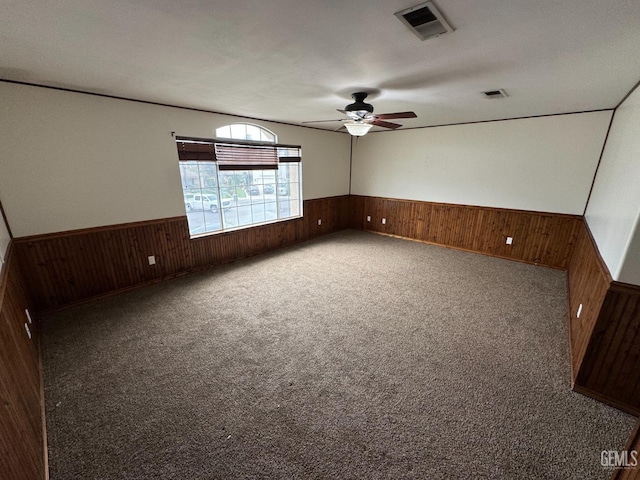 6100 Aruba Ct, Bakersfield, CA 93313 - carpeted empty room featuring wooden walls and wainscoting