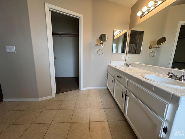 6100 Aruba Ct, Bakersfield, CA 93313 - full bathroom featuring a sink, a walk in closet, double vanity, and tile patterned floors
