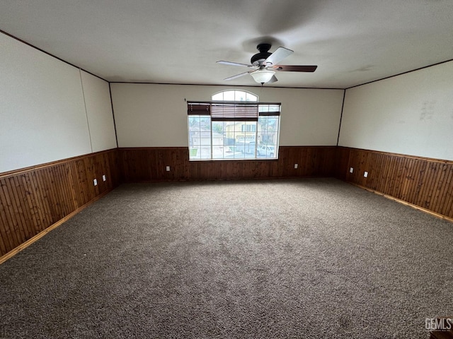 6100 Aruba Ct, Bakersfield, CA 93313 - carpeted spare room featuring ceiling fan, wood walls, and wainscoting