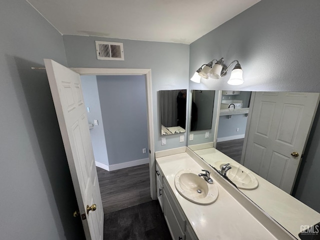 6100 Aruba Ct, Bakersfield, CA 93313 - bathroom featuring vanity, wood finished floors, visible vents, and baseboards