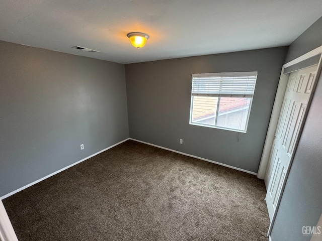 6100 Aruba Ct, Bakersfield, CA 93313 - unfurnished bedroom featuring dark colored carpet, visible vents, baseboards, and a closet