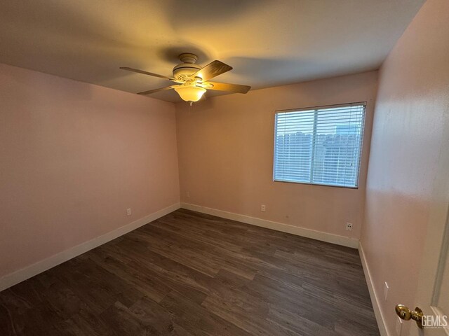 6100 Aruba Ct, Bakersfield, CA 93313 - spare room featuring dark wood finished floors, a ceiling fan, and baseboards