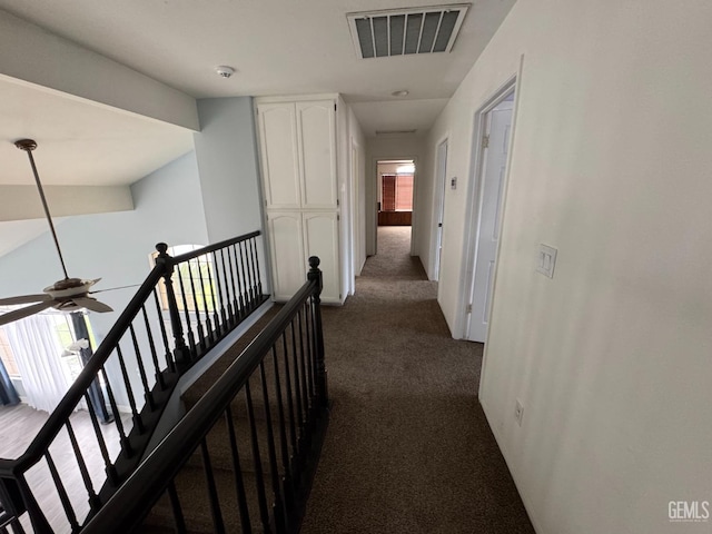 6100 Aruba Ct, Bakersfield, CA 93313 - hall with visible vents, an upstairs landing, and dark carpet
