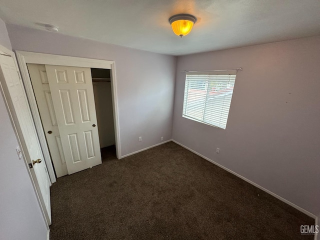 6100 Aruba Ct, Bakersfield, CA 93313 - unfurnished bedroom with a closet, dark carpet, and baseboards