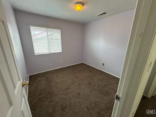 6100 Aruba Ct, Bakersfield, CA 93313 - spare room featuring visible vents, baseboards, and dark colored carpet