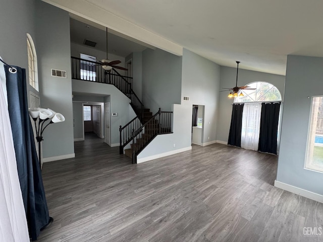 6100 Aruba Ct, Bakersfield, CA 93313 - unfurnished living room featuring visible vents, stairs, ceiling fan, and wood finished floors