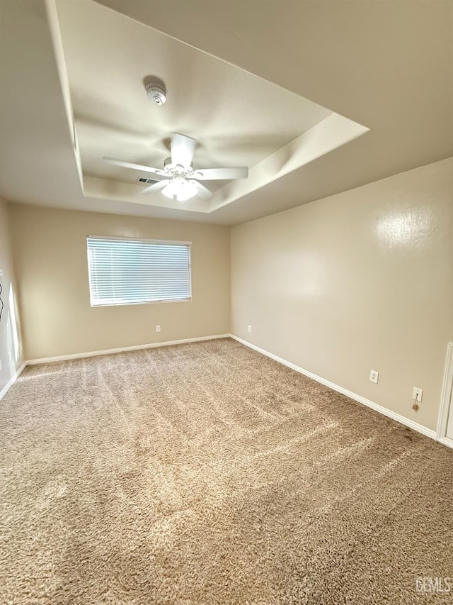 6631 Rimridge Way, Bakersfield, CA 93313 - unfurnished room featuring a raised ceiling, ceiling fan, carpet floors, and baseboards