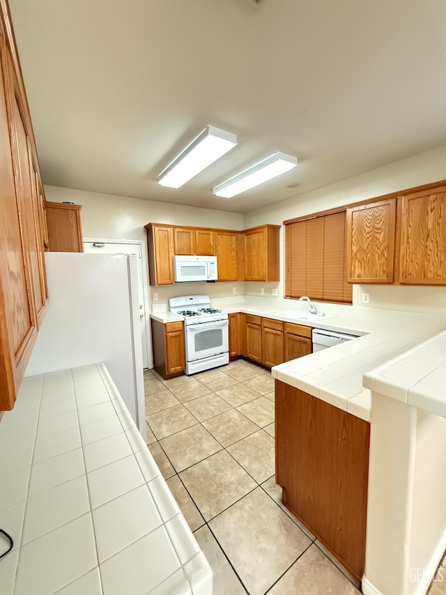 6631 Rimridge Way, Bakersfield, CA 93313 - kitchen featuring white appliances, a sink, brown cabinets, and light tile patterned floors