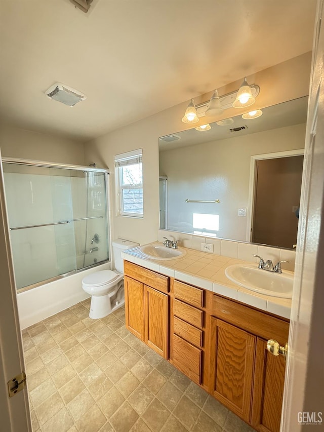 6631 Rimridge Way, Bakersfield, CA 93313 - full bath with double vanity, combined bath / shower with glass door, and toilet